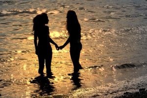 two girls standing in the ocean