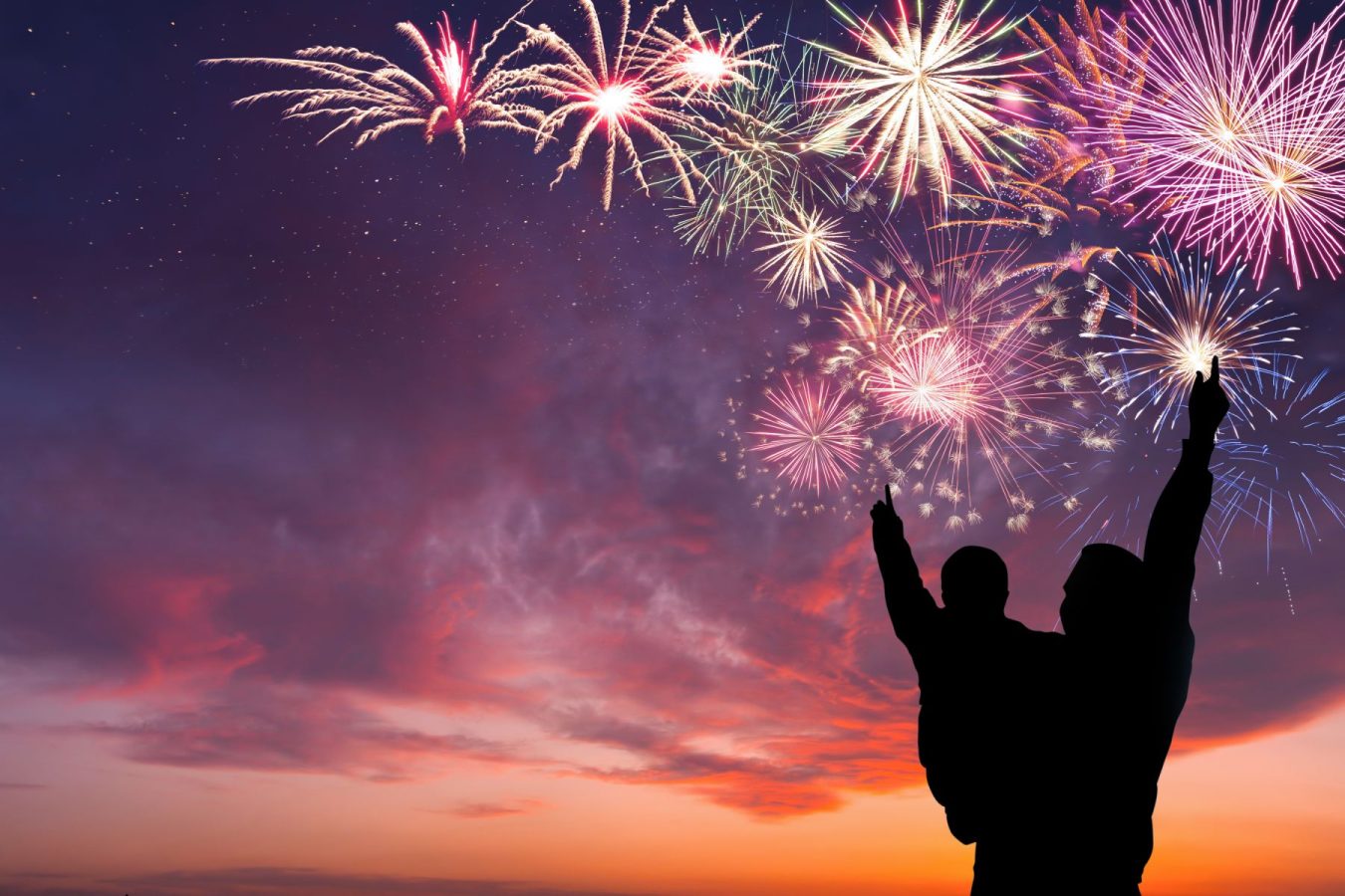 child and parent enjoying fireworks