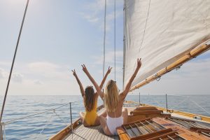 girls-cheering-on-sailboat