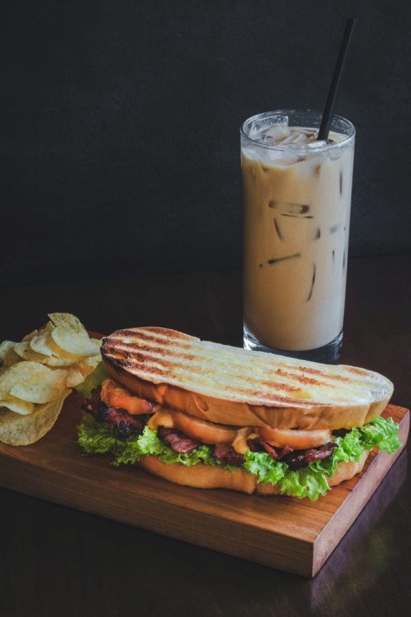 plate with a BLT and an iced coffee as the drink